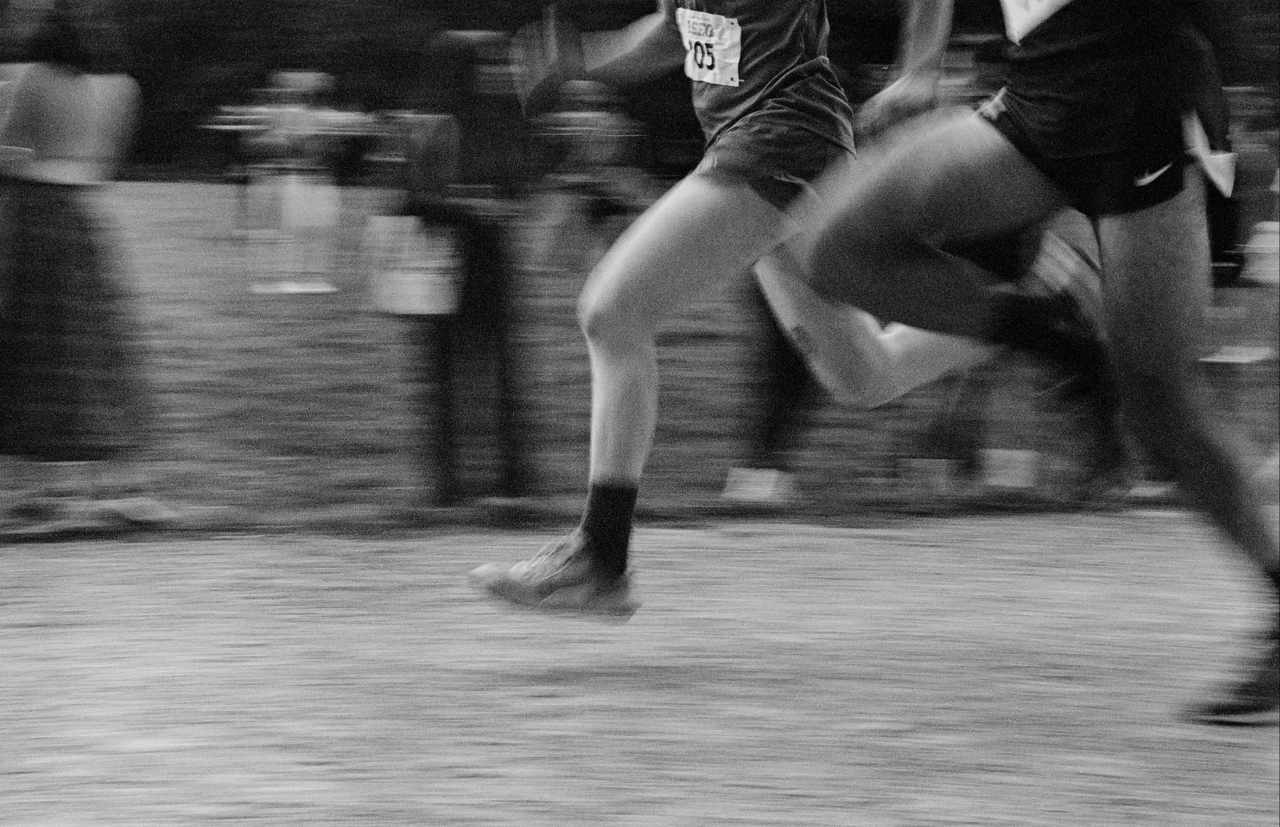 Runners racing on the road wearing modern performance running shoes